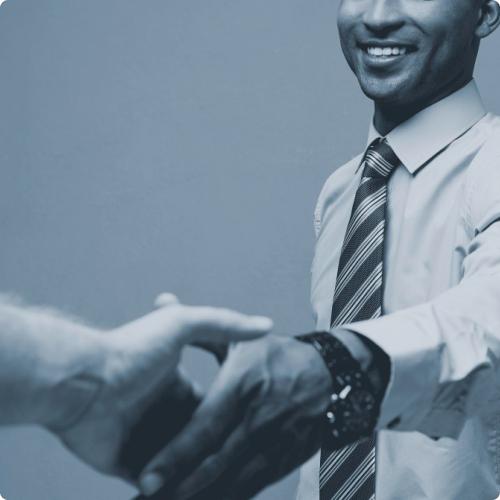 Smiling businessman reaching to shake hands
